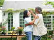 © chayathon2000 - Senior couple laughing together in home garden.