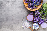 Fototapeta Lawenda - Essential lavender salt with flowers top view.