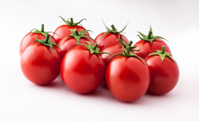 Wall Mural - Tomatoes fresh colorful arrangement lined up isolated on white background in studio