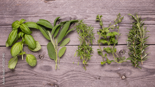 Fototapeta na drzwi i meble fresh types of aromatic herbs on the raw wooden table