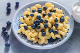 Fototapeta Mapy - Pasta with blueberries and sour cream.