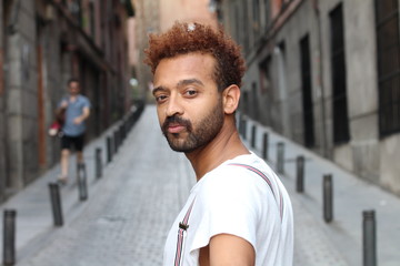 Man looking over his shoulder on the street 