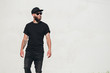 © 4Max - Hipster handsome male model with beard wearing black blank t-shirt with space for your logo or design in casual urban style
