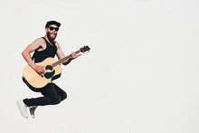 Guitar Player Singing Outside. Hipster Guitar Player With Beard And Black Clothes
