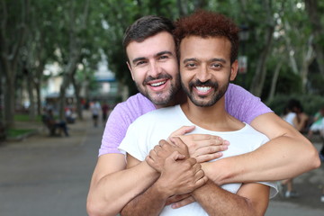 Wall Mural - Gay couple holding each other outdoors