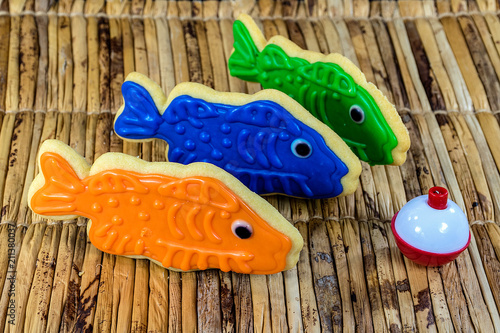 Fotografie, Obraz fish cookies with red and white fishing bobber on bamboo mat