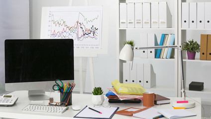 Workplace with notebook laptop Comfortable work table in office windows and city view