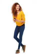 Full Body Happy Woman With Cellphone Laughing Against Isolated White Background