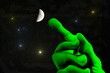© waldwiese - universe - green alien hand with outstretched finger pointing to the moon and the stars