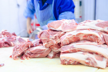 Meat deboning shop. Butcher. Butchers are cutting pork. Line of production of sausage delicacies