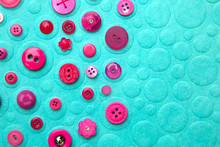 Pink Buttons On Turquoise Background