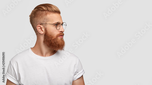 Profile Shot Of Handsome Male With Trendy Hairdo And Beard
