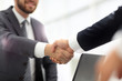 © ASDF - Confident businessman shaking hands