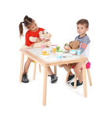 Canvas Print - Little children playing tea party with toys on white background. Indoor entertainment