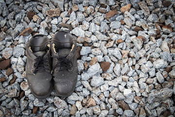 Old shoes on stone background, lifestyle concept.