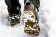 © alicja neumiler - Black boots in snow, person put the step in snow, hiking in winter