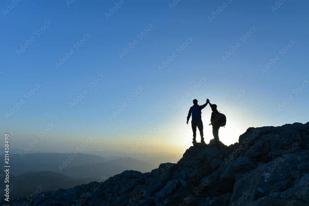 Couple hikers success concept in mountains - obrazy, fototapety, plakaty 