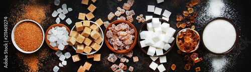 Fotografía Set of different white and brown sugar in assortment, dark background, banner, t