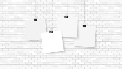 Wall Mural - Posters on binder clips. Paper templates on brick wall. Realistic mock up. Empty notepad sheet for your business design. Brick wall. Vector templates for lettering, quote, images or logos.