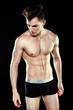 © smmartynenko - Handsome sporty young man in underwear posing on dark background
