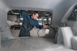 © artpodporin - employee of car-care center/ The employee of car-care center in overalls with a steam generator for a dry-cleaner of salon of the car