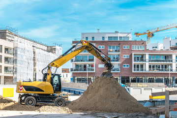 excavator in construction site. buildingindustry and new building concept