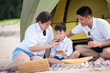 © ic36006 - Summer vacation. Family camping on beach with tent.