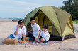 © ic36006 - Summer vacation. Family camping on beach with tent.