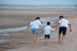 © ic36006 - Happy family on the beach. Parents with Children enjoying a holiday at the sea. Summer vacation concept