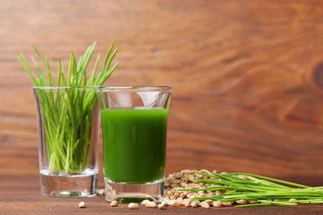 Shot of healthy wheat grass juice. Fitness, diet and detox beverage. Superfood.