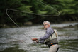Fisherman fly-fishing in river