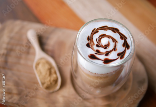 Fotografie, Obraz Hot mocha coffee latte art chocolate heart shape spiral glass on table backgroun