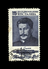 Wall Mural - Joseph Stalin, famous soviet politician leader, 75th birth anniversary, circa 1954.. vintage canceled postal stamp printed in USSR (Soviet Union) isolated on black background.