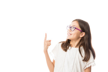 Portrait of cheerful smiling girl points hand and finger up to something