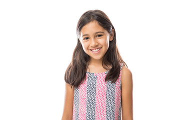 smiling young hispanic girl posing and looking at the camera over white background