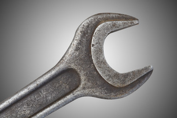 Wall Mural - Old spanner on grey background