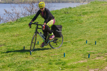 woman bicyclist compete during cycling tourism competition