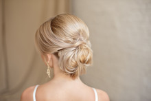 Rear View Of Female Hairstyle Middle Bun With Blond Hair.