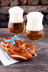 Original bavarian pretzels with beer on wooden board. Oktoberfes