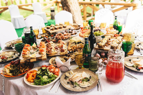 Festive Rich Round Table With White Tablecloth And Chairs Served