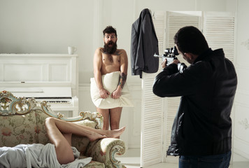 i will kill you. husband holding gun and keeping in front of lover and wife lying in bed