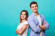 © F8  \ Suport Ukraine - Confident casual man and woman with hands crossed laughing for the camera on mint background