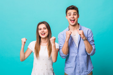 Sticker - Young couple scream gesture of win isolated on mint background