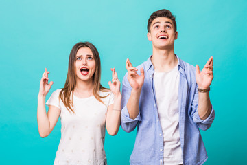 Sticker - Happy casual couple pointing up to something on mint blue background