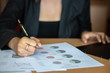 © May Chanikran - Close up of woman hand taking notes at a business meeting for personal reference, while meeting minutes are for official record-keeping purposes.