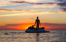 Silhouette Of A Man On A Jet Ski In The Sun