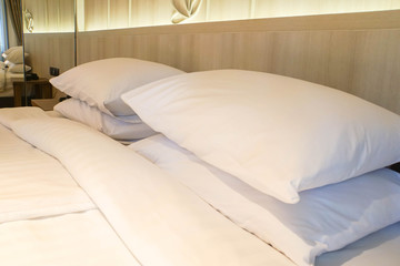 close up comfy white pillows on mattress in luxury hotel bedroom