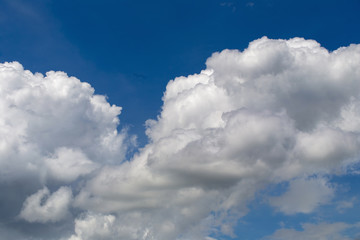 White fluffy clouds in the blue sky background