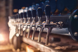 Fototapeta  - Beer tap in the row
