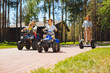 © zinkevych - We love driving. Joyful cute kids spending time with their parents and driving ATVs